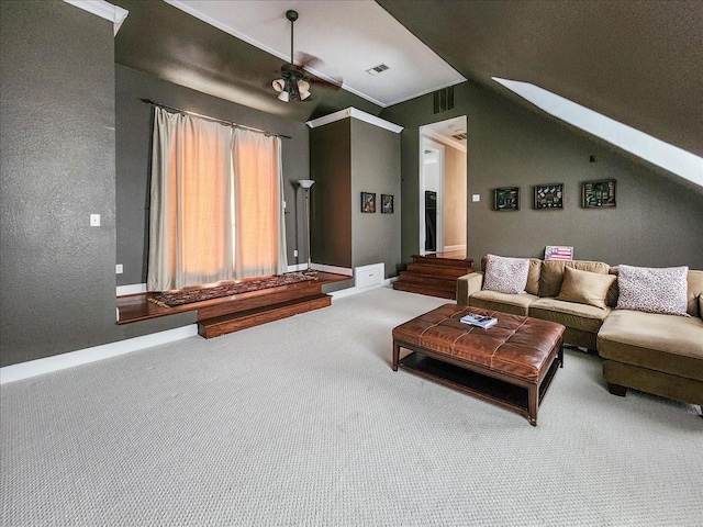 living area with visible vents, lofted ceiling with skylight, carpet floors, baseboards, and a textured wall