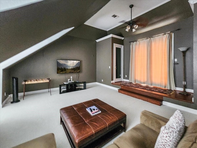 living area featuring visible vents, carpet flooring, a ceiling fan, and vaulted ceiling