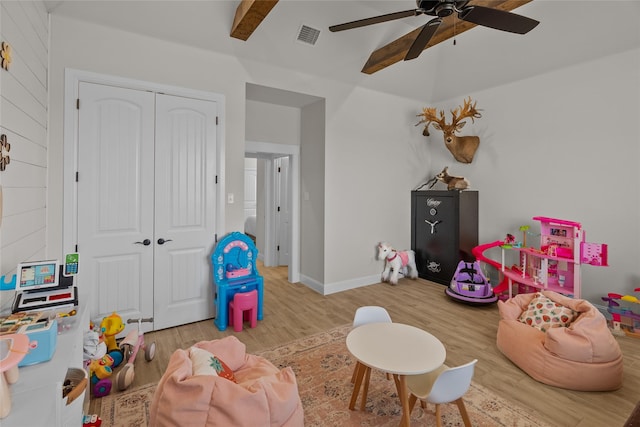 recreation room featuring ceiling fan, wood finished floors, visible vents, and baseboards