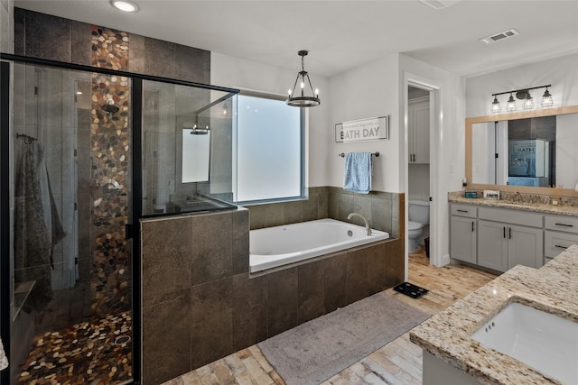 full bathroom with vanity, wood finished floors, visible vents, a shower stall, and toilet