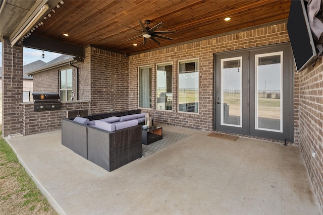 view of patio / terrace with ceiling fan, an outdoor living space, area for grilling, and an outdoor kitchen