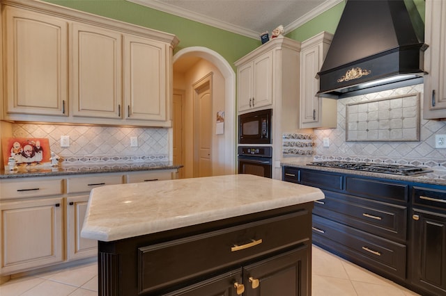 kitchen featuring arched walkways, black appliances, custom range hood, cream cabinetry, and crown molding