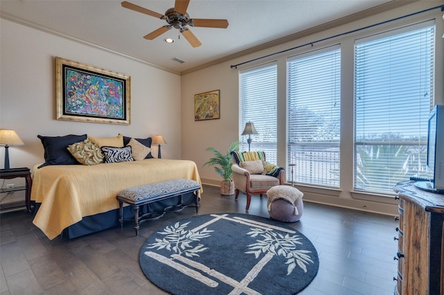 bedroom with ceiling fan, visible vents, ornamental molding, and dark wood finished floors