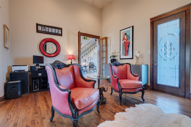 living area with french doors and wood finished floors