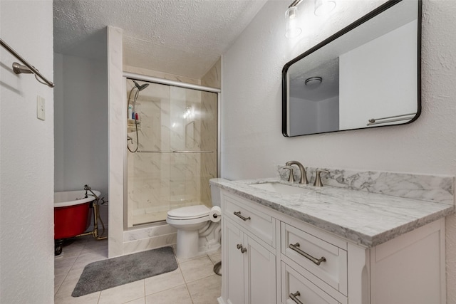 bathroom with a shower stall, a textured ceiling, vanity, and toilet