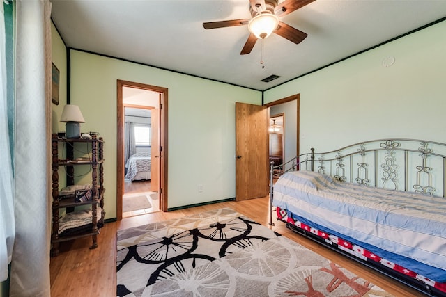 bedroom with baseboards and wood finished floors