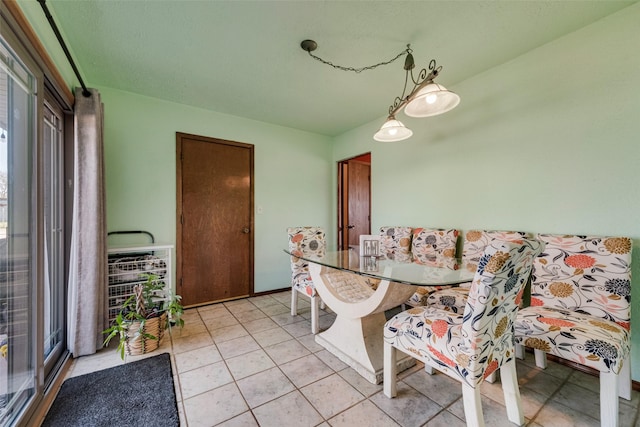 dining area with light tile patterned floors and a healthy amount of sunlight