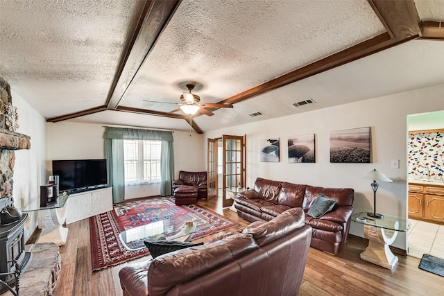 living room featuring french doors, a textured ceiling, ceiling fan, and wood finished floors