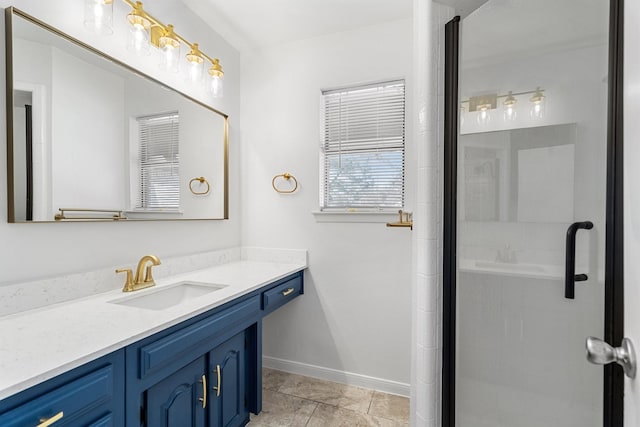 bathroom with a stall shower, vanity, and baseboards