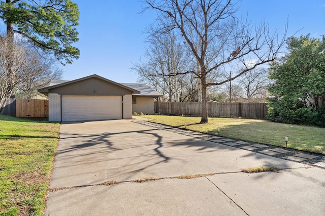 view of property exterior featuring a lawn, driveway, and fence