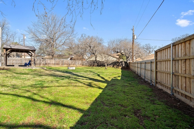 view of yard featuring a gazebo and a fenced backyard