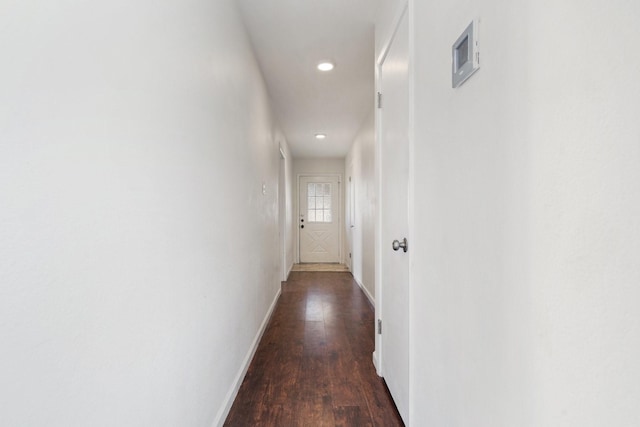 hall featuring wood finished floors, recessed lighting, visible vents, and baseboards