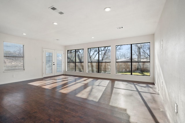 unfurnished living room with recessed lighting, visible vents, hardwood / wood-style floors, and french doors