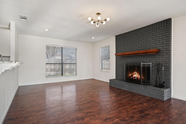 926 Harber Ave, Grapevine, TX 76051 - unfurnished living room featuring a chandelier, a brick fireplace, wood finished floors, baseboards, and recessed lighting