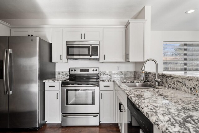 926 Harber Ave, Grapevine, TX 76051 - kitchen featuring stainless steel appliances, a sink, dark wood-style floors, light stone counters, and recessed lighting