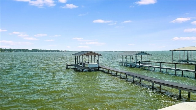 dock area with a water view and boat lift