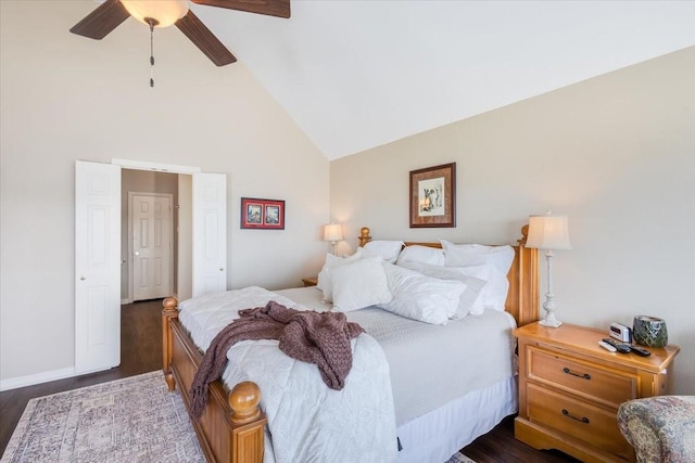 bedroom featuring dark wood finished floors, high vaulted ceiling, and ceiling fan