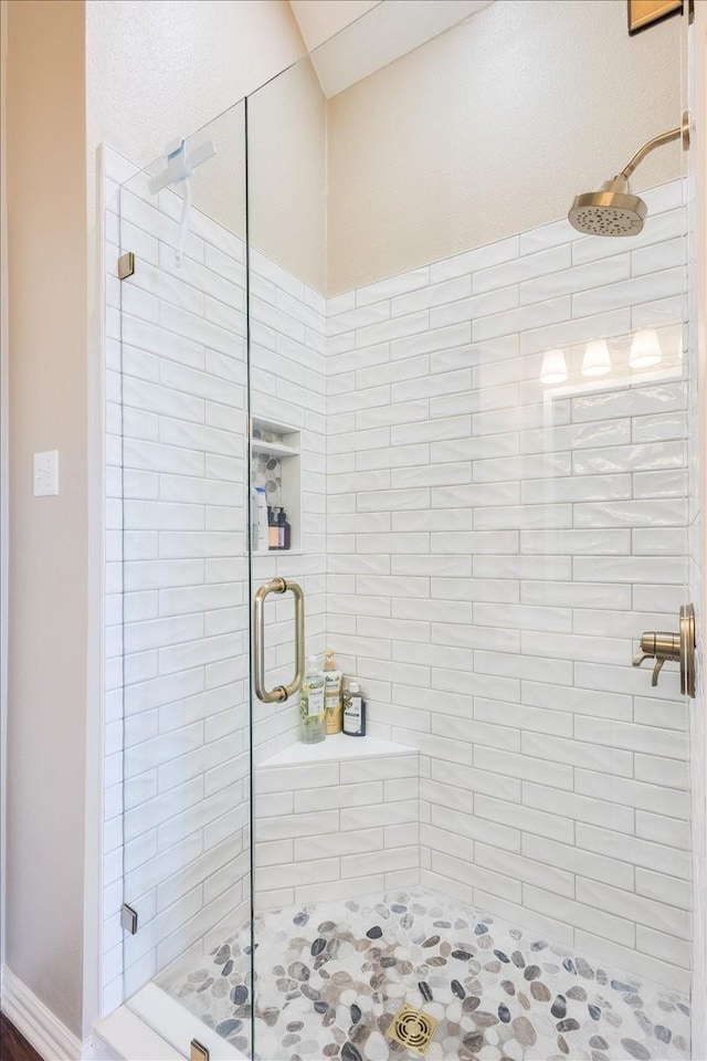 bathroom with a shower stall