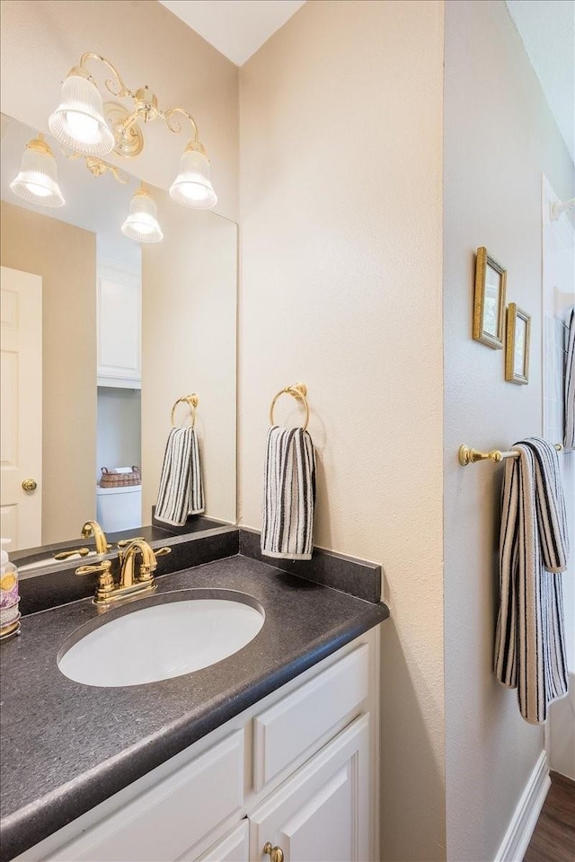 bathroom with vanity and baseboards