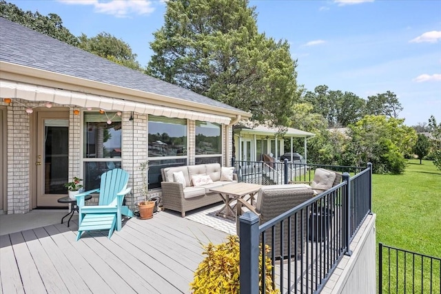 deck with an outdoor living space and a yard