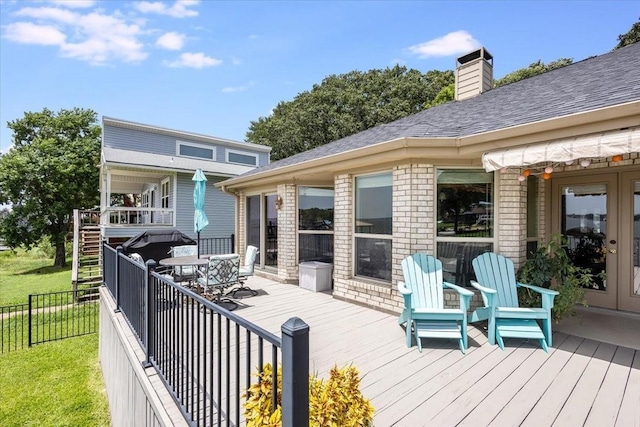 wooden deck featuring outdoor dining space and fence