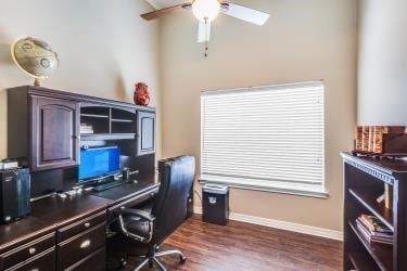 office area featuring dark wood-style flooring, baseboards, and ceiling fan