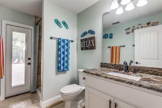 bathroom with visible vents, a shower with curtain, toilet, baseboards, and vanity