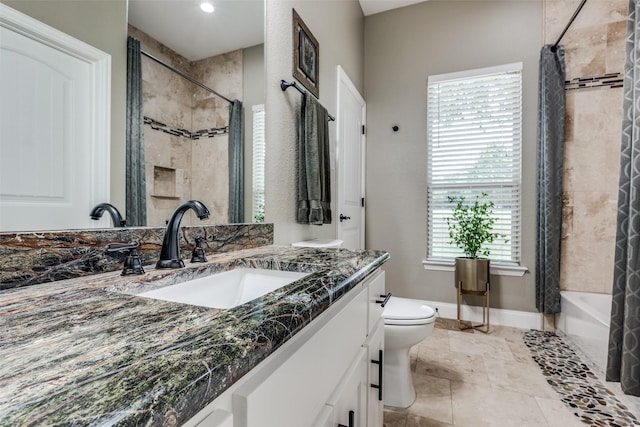 full bathroom featuring shower / tub combo, baseboards, toilet, and vanity