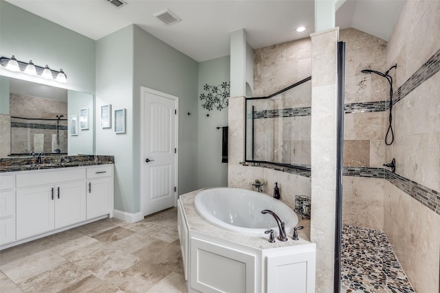 full bathroom featuring a bath, visible vents, a stall shower, and vanity