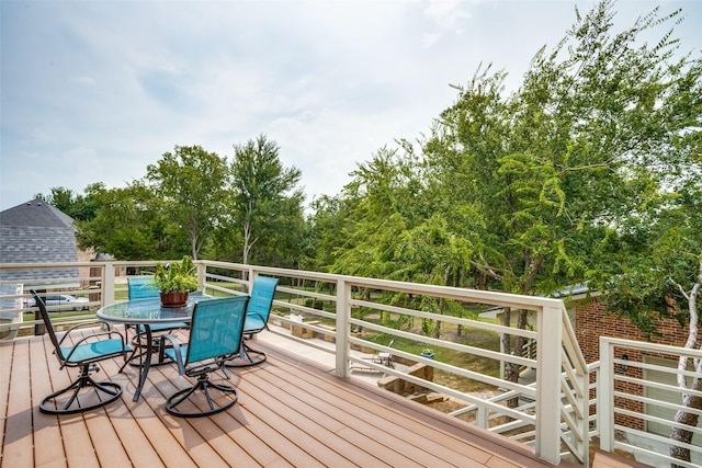 wooden terrace featuring outdoor dining space