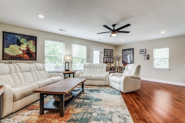 living area with wood finished floors, visible vents, baseboards, recessed lighting, and ceiling fan