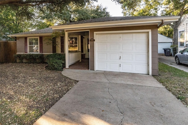 single story home with concrete driveway and a garage