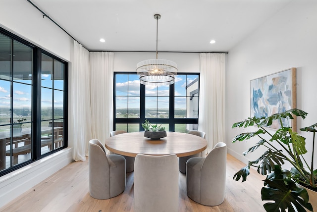 dining room featuring a notable chandelier, light wood-style floors, recessed lighting, and baseboards