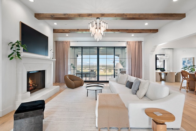 living room with beamed ceiling, recessed lighting, a lit fireplace, and wood finished floors