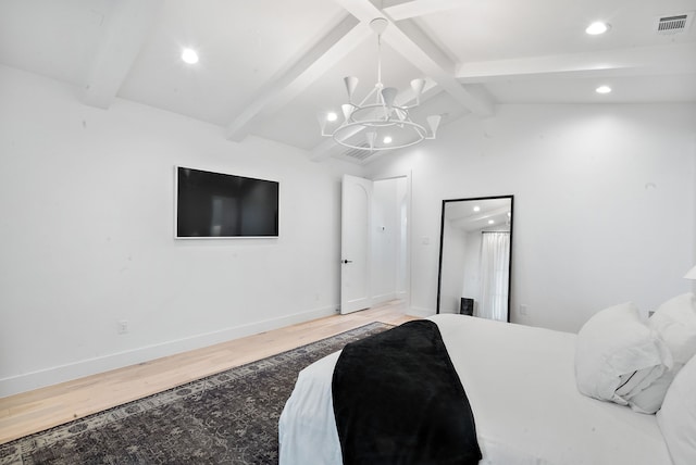 bedroom with wood finished floors, visible vents, baseboards, an inviting chandelier, and vaulted ceiling with beams