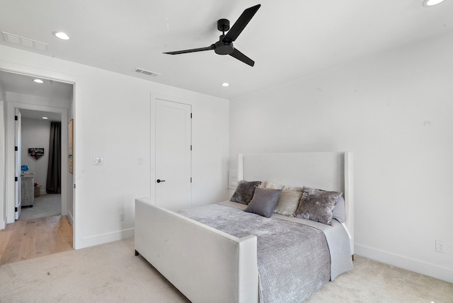 bedroom with baseboards, recessed lighting, visible vents, and light carpet