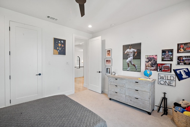 bedroom with a ceiling fan, light colored carpet, and visible vents