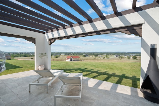 view of patio / terrace with a rural view and a pergola