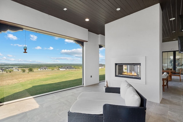 view of patio / terrace with an outdoor living space with a fireplace