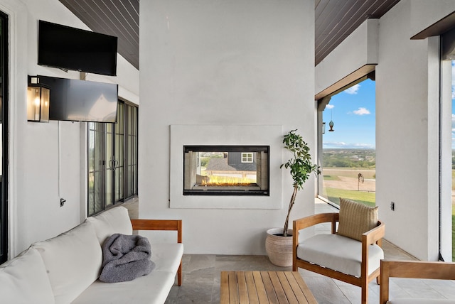 living area featuring a multi sided fireplace