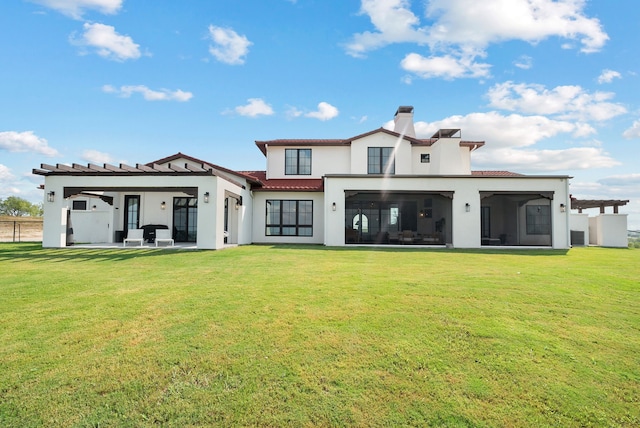 rear view of property with stucco siding, a patio, a lawn, and a sunroom