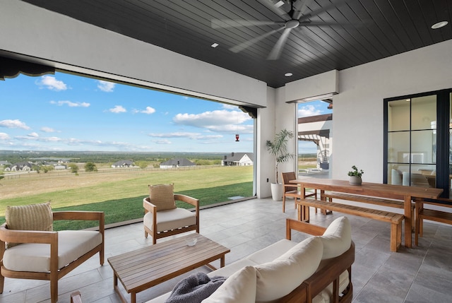 view of patio with outdoor lounge area, outdoor dining area, and a ceiling fan