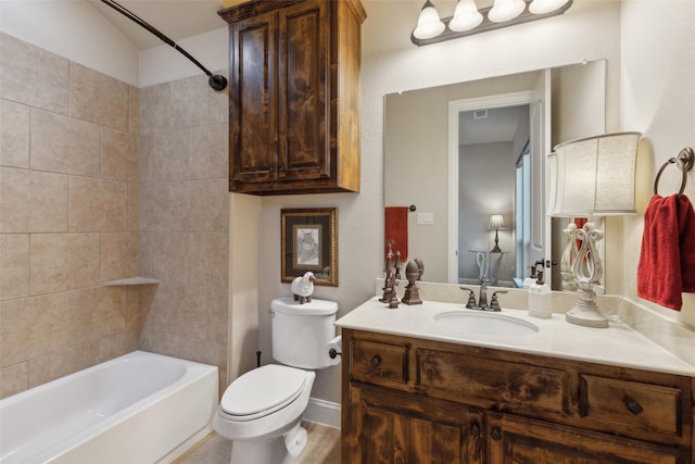 full bathroom featuring toilet, vanity, baseboards, and washtub / shower combination