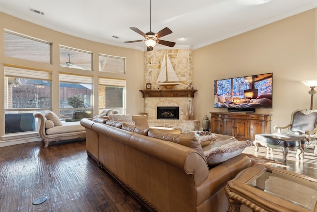 living area featuring a fireplace, crown molding, dark wood-style floors, and visible vents