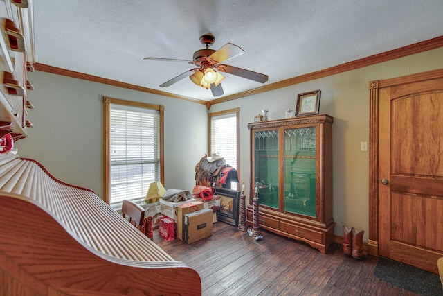 bedroom featuring a ceiling fan, a textured ceiling, hardwood / wood-style floors, and crown molding