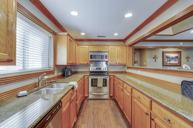 kitchen with dark wood-style floors, light stone countertops, a sink, stainless steel appliances, and crown molding