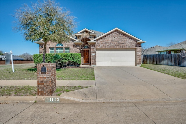 view of front of property featuring fence, concrete driveway, an attached garage, a front yard, and brick siding