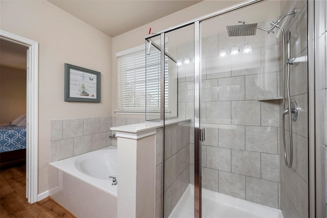 full bath featuring a garden tub, wood finished floors, a stall shower, and connected bathroom