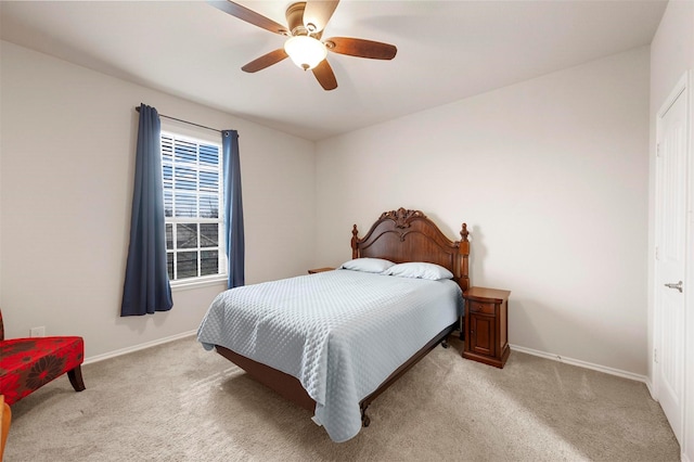 bedroom featuring baseboards, light colored carpet, and a ceiling fan