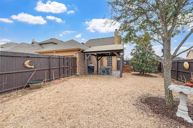 view of yard featuring a gazebo, a patio, and a fenced backyard